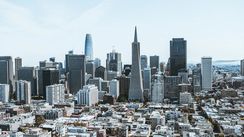 High angle view of modern buildings in city against sky