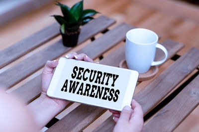 High angle view of person holding text on table