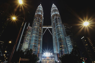 Low angle view of illuminated buildings against sky at night