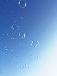 Close-up of bubbles against blue background