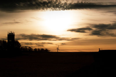 Scenic view of silhouette field against sky during sunset