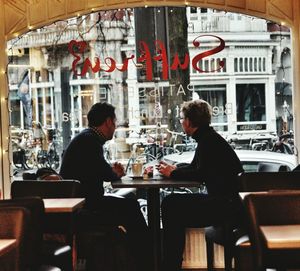 Rear view of woman sitting in restaurant