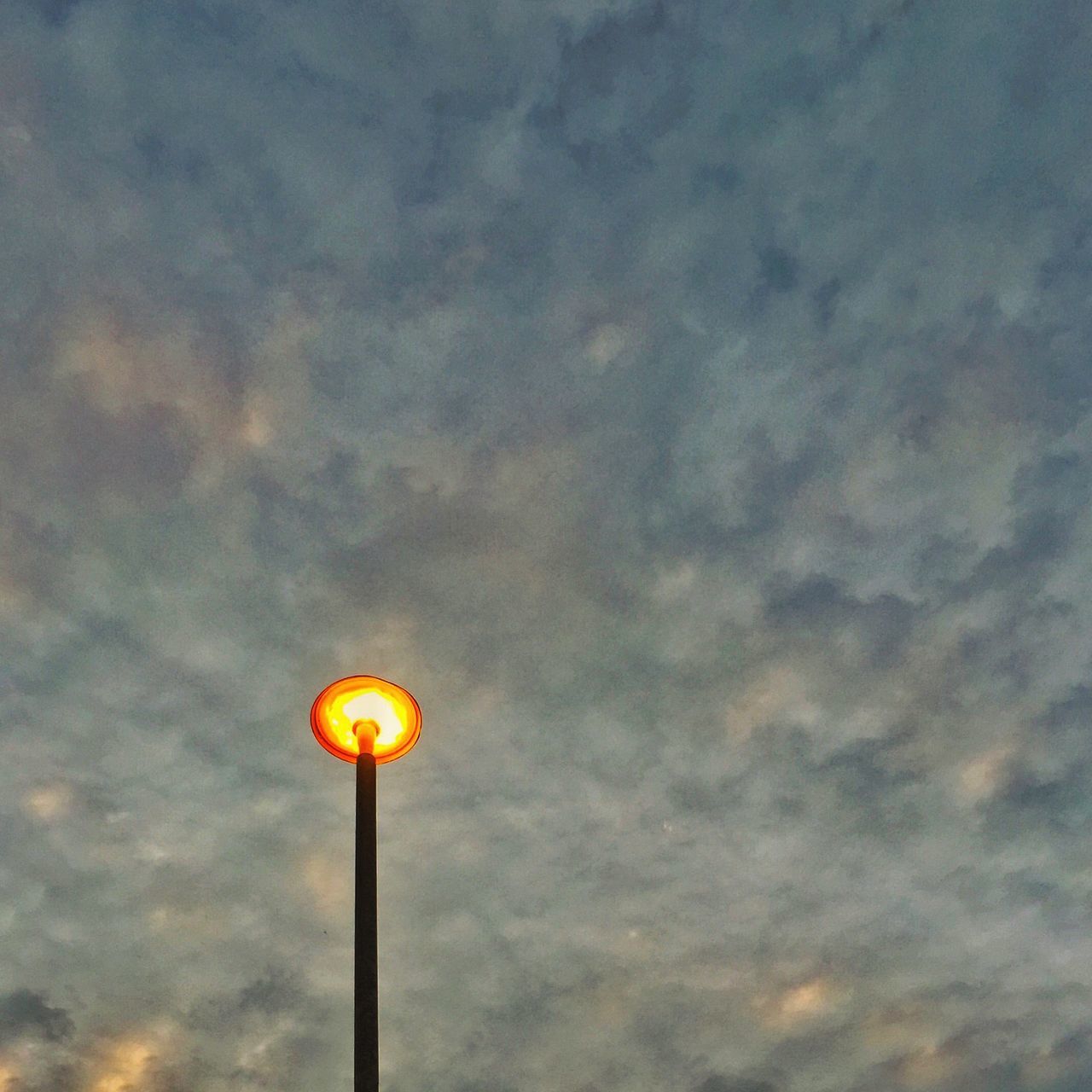 low angle view, sky, lighting equipment, street light, cloud - sky, yellow, sunset, illuminated, nature, orange color, beauty in nature, cloudy, dusk, no people, outdoors, sphere, cloud, electric light, tranquility, balloon