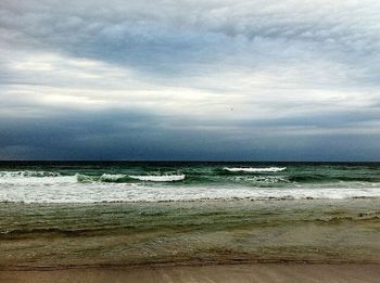 Scenic view of sea against cloudy sky