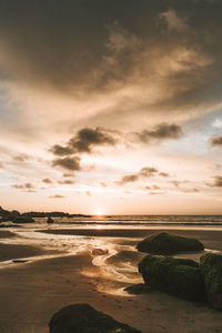 Scenic view of beach against sky during sunset