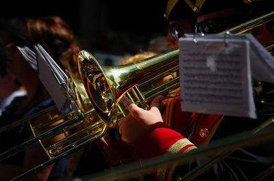 Midsection of men playing trumpets