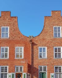 Low angle view of building against clear blue sky