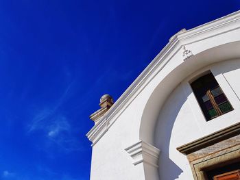 Low angle view of statue against blue sky