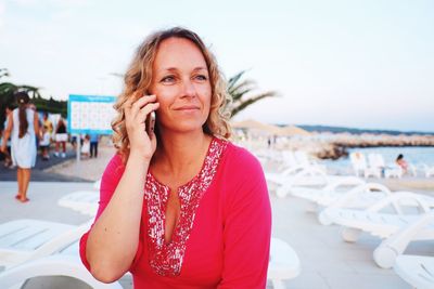 Smiling mature woman talking on mobile phone