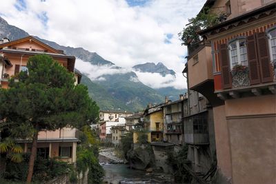 Houses by mountains against sky