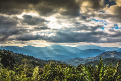 Scenic view of mountains against cloudy sky