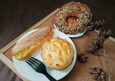 Freshly baked multi grain bagels,durian pastry with custard cream eclair for breakfast.