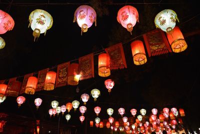 Low angle view of lanterns hanging at night