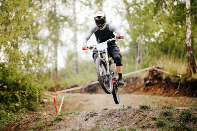 Man riding bicycle in forest