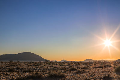 Scenic view of mountains against clear sky during sunset