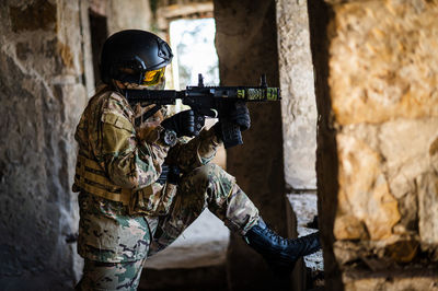 Rear view of man standing against wall