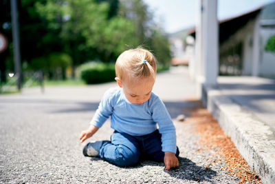 Cute boy sitting outdoors