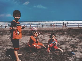 People on beach against sky