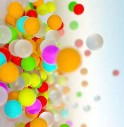 Full frame shot of multi colored balloons against white background