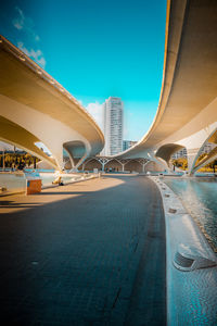 View of bridge in city against blue sky