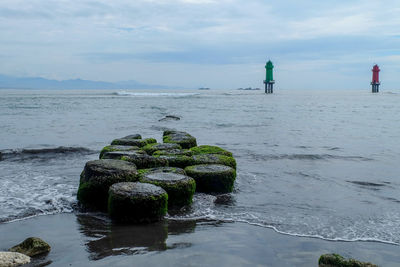 Scenic view of rocks in sea against sky