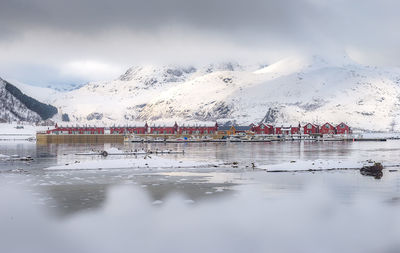 Scenic view of snowcapped mountains against cloudy sky