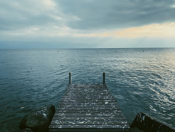 Pier over sea against sky