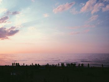 People on beach at sunset