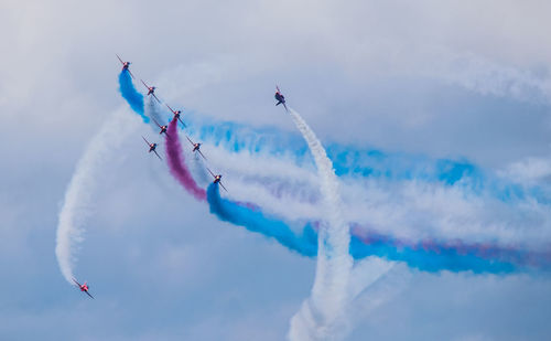 Low angle view of airshow against sky