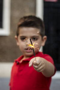 Portrait of a boy holding flower