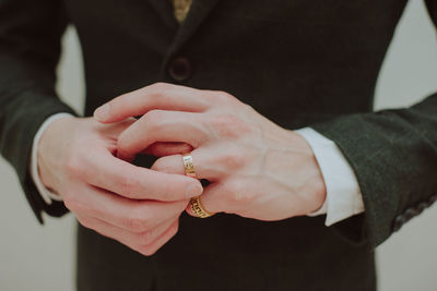 Midsection of couple holding hands