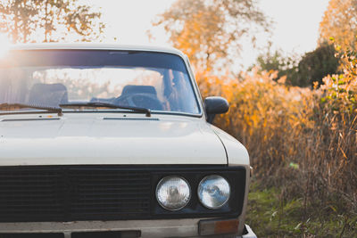 Close-up of abandoned soviet car on field