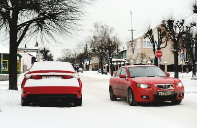 Red car on road in winter