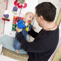 Father playing with son at home