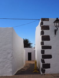 White wall of building against clear blue sky