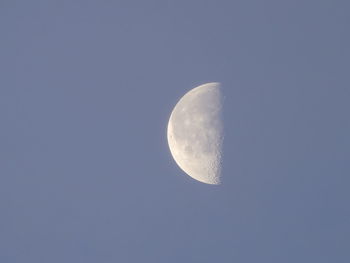 Low angle view of moon against clear blue sky