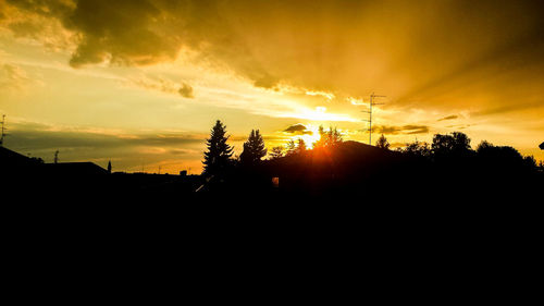 Silhouette trees against sky during sunset