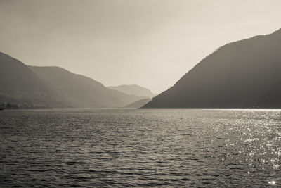 Scenic view of sea and mountains against sky