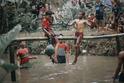 High angle view of people on wet shore