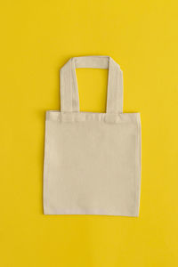 High angle view of bag against yellow background