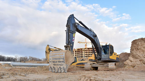 Excavator during excavation at construction site. backhoe on foundation work in sand pit. 