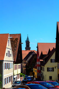 View of buildings in city against clear blue sky