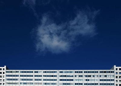 Low angle view of buildings against blue sky