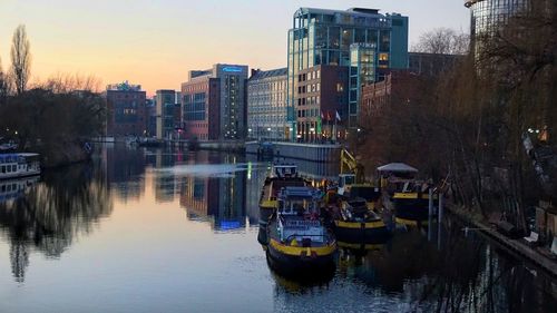 Boats moored on river in city