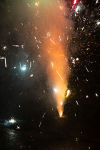 Low angle view of firework display at night