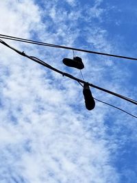 Low angle view of power lines against sky