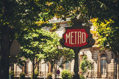 Low angle view of paris metro sign