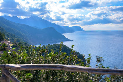 Scenic view of sea and mountains against sky