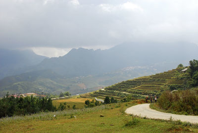 Scenic view of mountains against cloudy sky