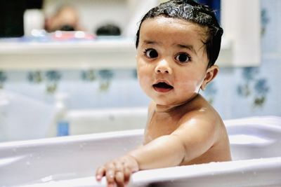 Portrait of shirtless man in bathroom